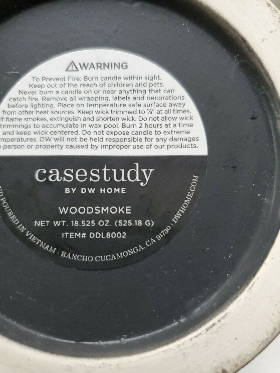 DW Home 18.5 oz Woodsmoke candle in matte black jar with white abstract print and wooden lid