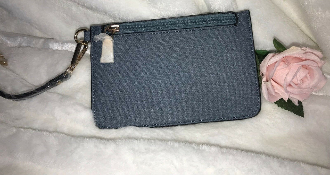 Blue wristlet with a pink rose on a white surface