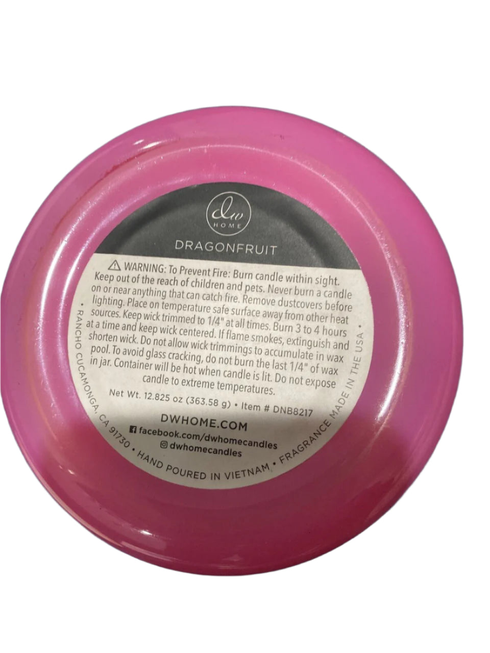 12 oz DW Home 3-wick candle in a pink and white ceramic jar, scented with dragonfruit, papaya, and melon