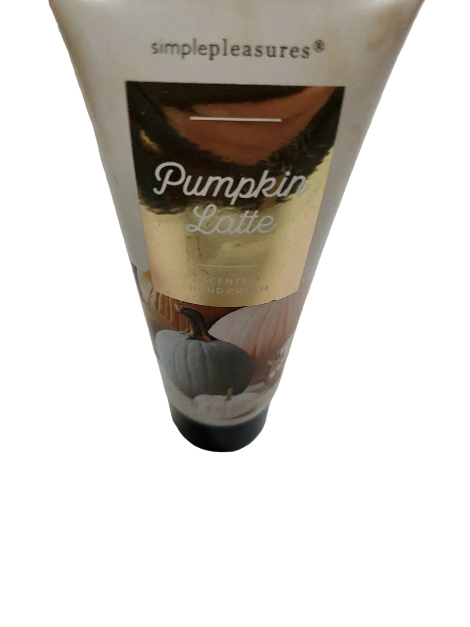 Tube of hand cream labeled 'Pumpkin Latte' on a white surface.