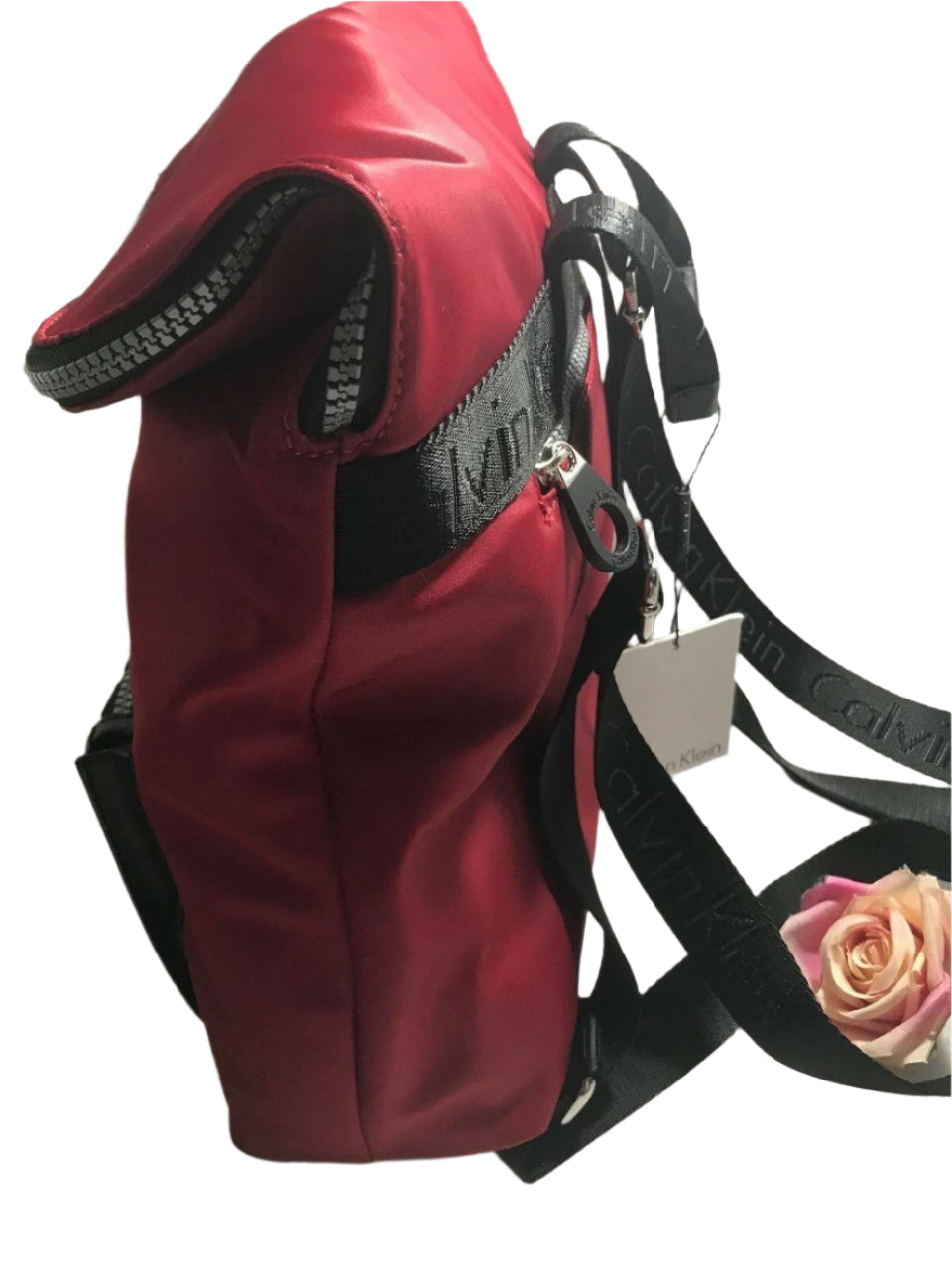 Red and black Calvin Klein backpack with large front logo, flap closure, and adjustable straps