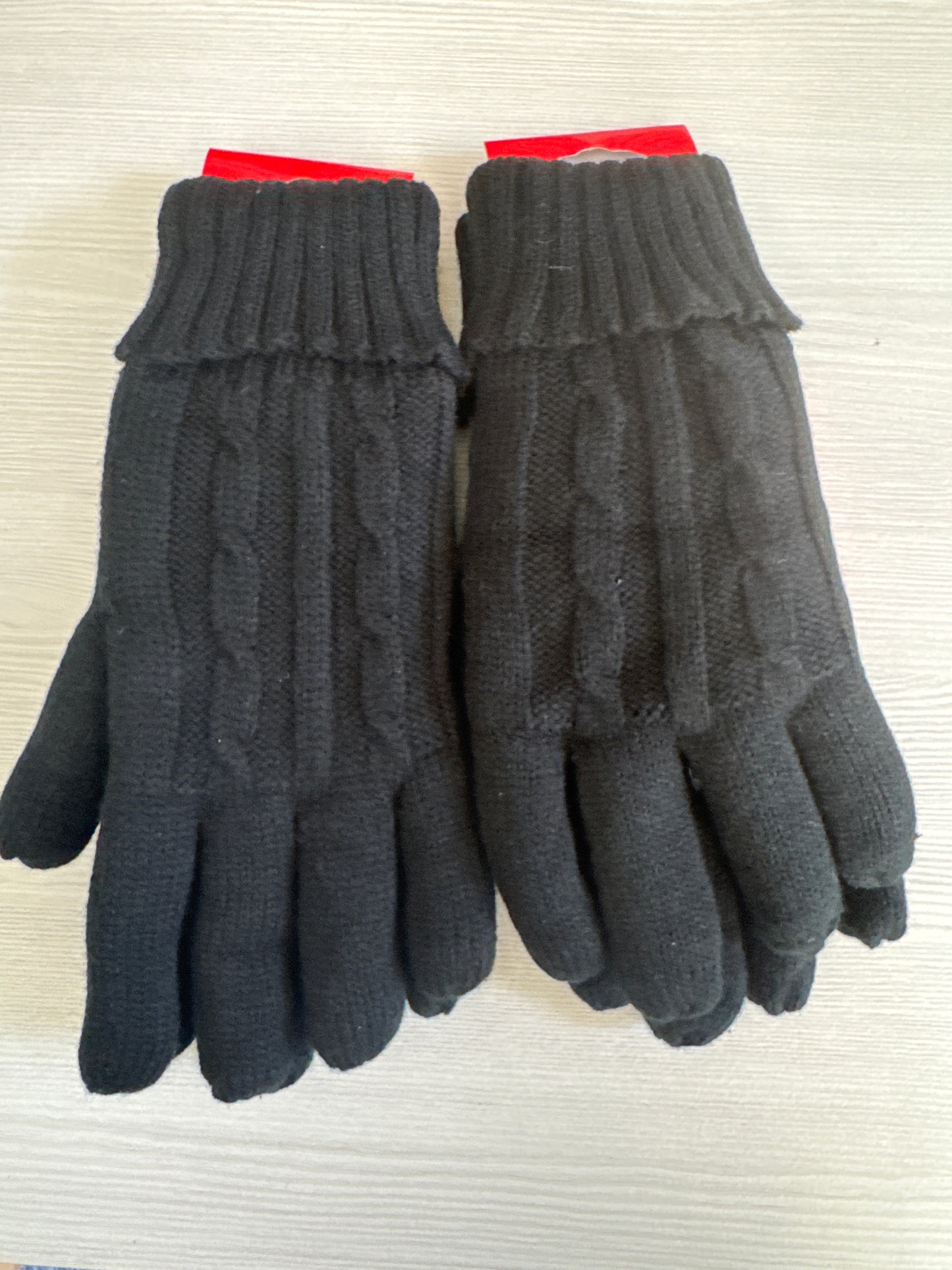 Two pairs of black Heat Locker thermal winter gloves with red and yellow packaging for cold weather insulation