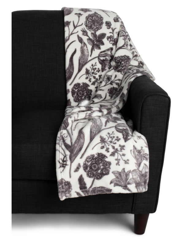 Velvet plush floral throw blanket draped over a chair, soft decorative accent