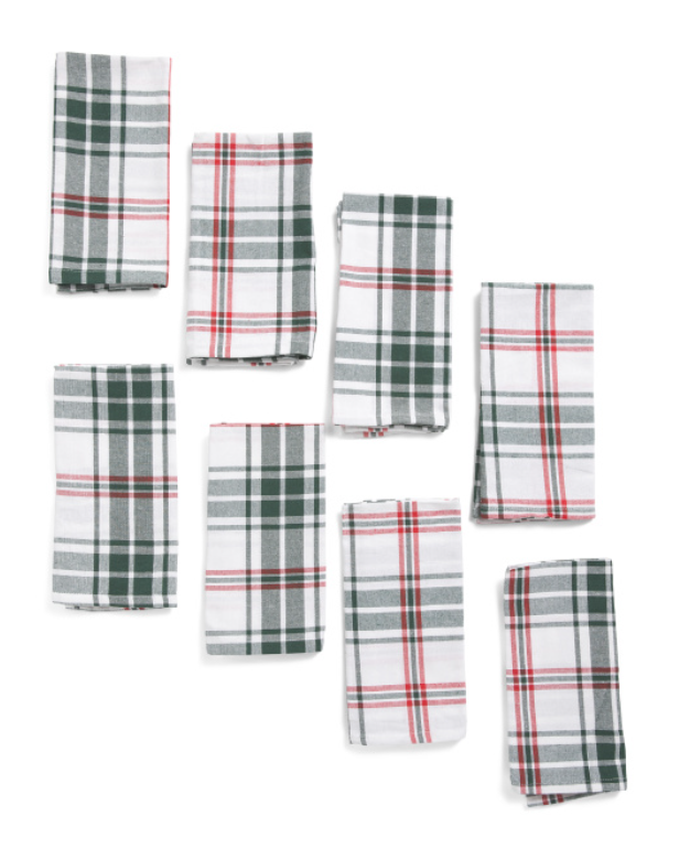 Set of eight plaid cotton napkins in white, green, and red holiday pattern.