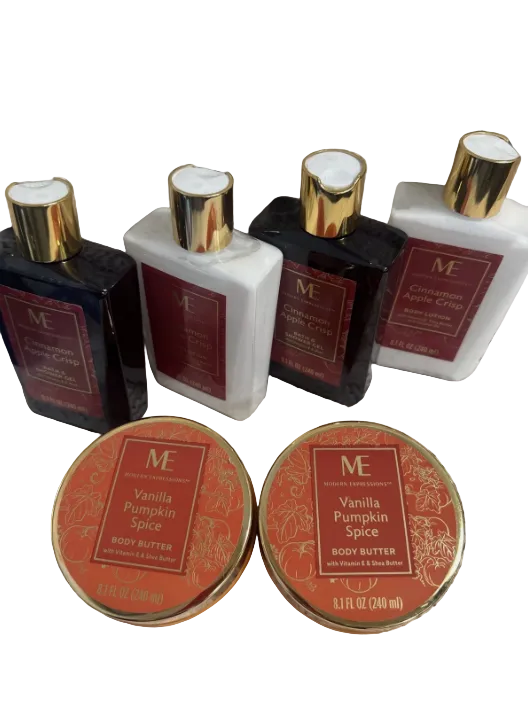 Collection of body care products including bottles and tins on a textured surface