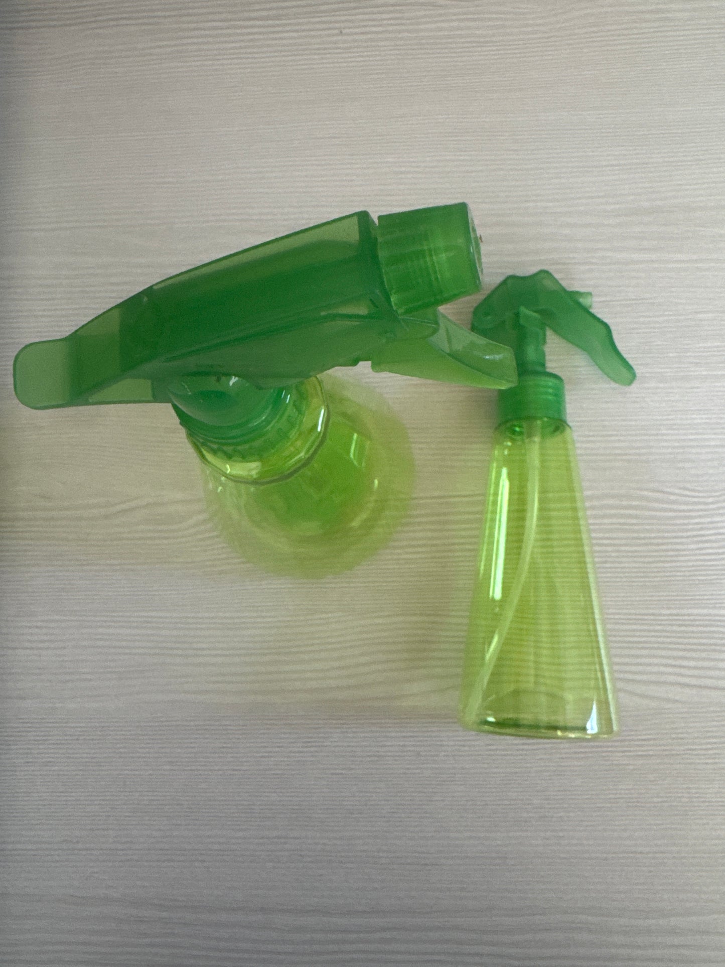 Green plastic spray bottle with trigger sprayer