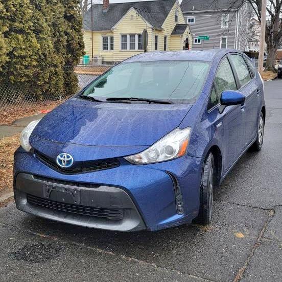 Front view of a 2015 Toyota Prius v Base in blue, parked on a residential street in Stratford, CT