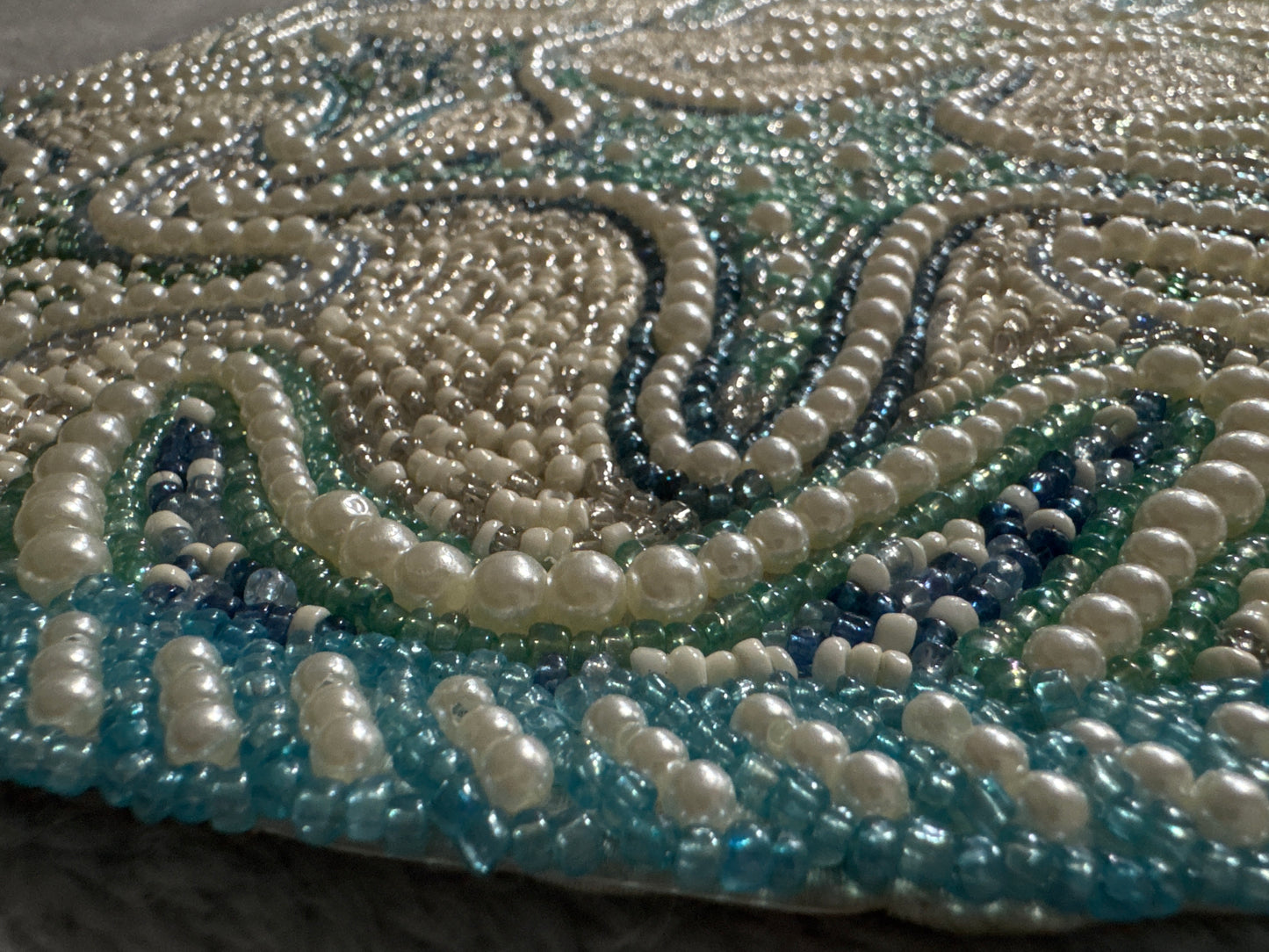 Handmade Round Starfish Beaded Placemat with intricate beading, featuring a coastal design with starfish patterns in soft shades of blue, green, and beige, 15-inch diameter