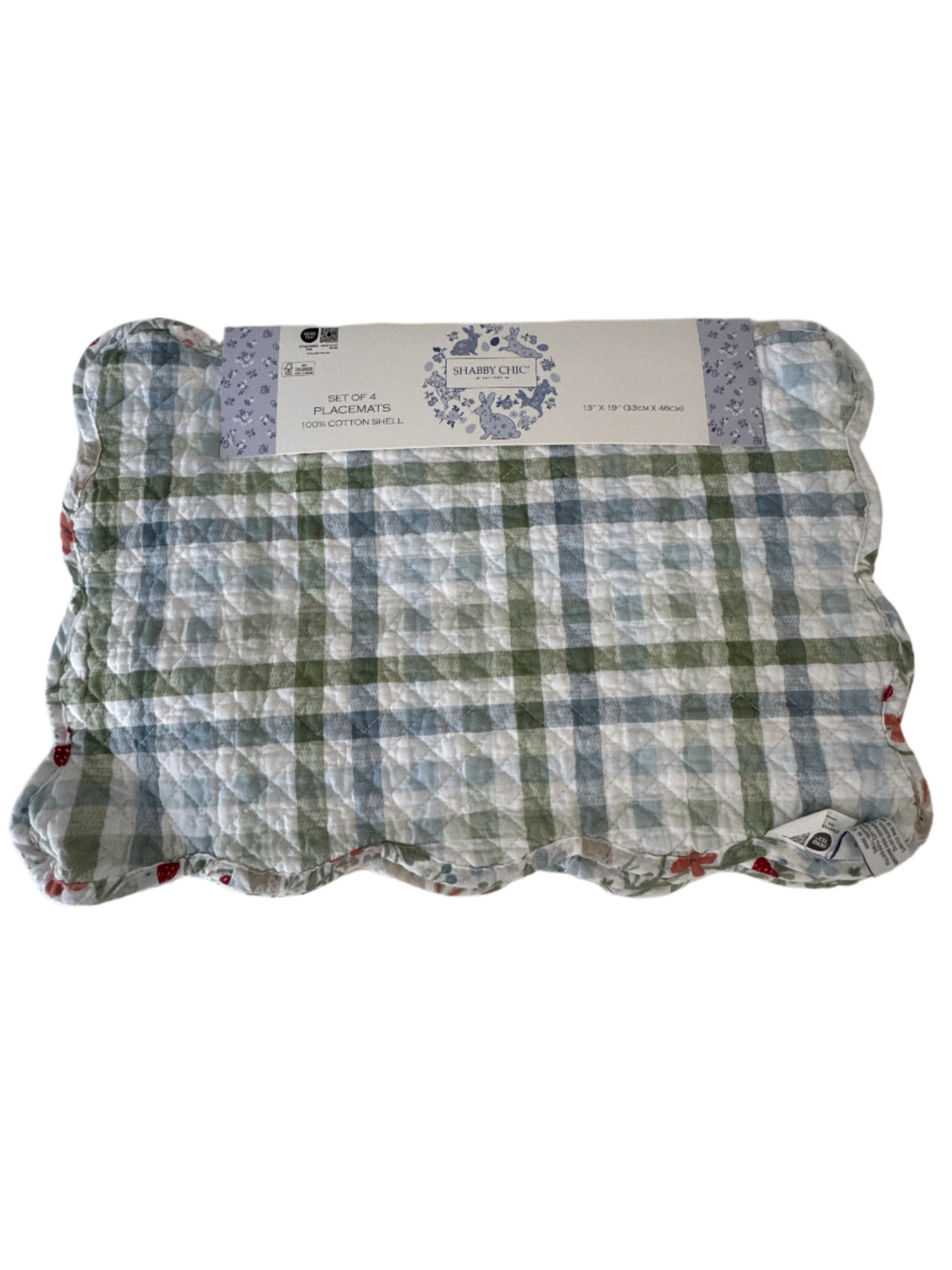 A set of 4 placemats in a green and blue plaid pattern, featuring a scalloped edge and a "Shabby Chic" label on the packaging