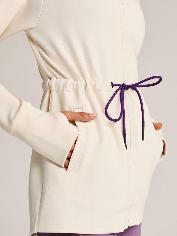 Women’s lightweight zip hoodie in ivory with adjustable drawstring waist and thumbholes