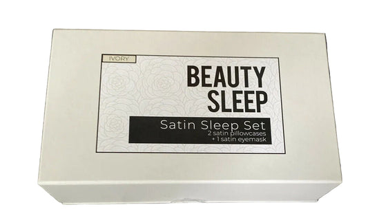 A white box labeled 'Beauty Sleep Satin Sleep Set Eye Mask & 2 Standard Pillowcases 