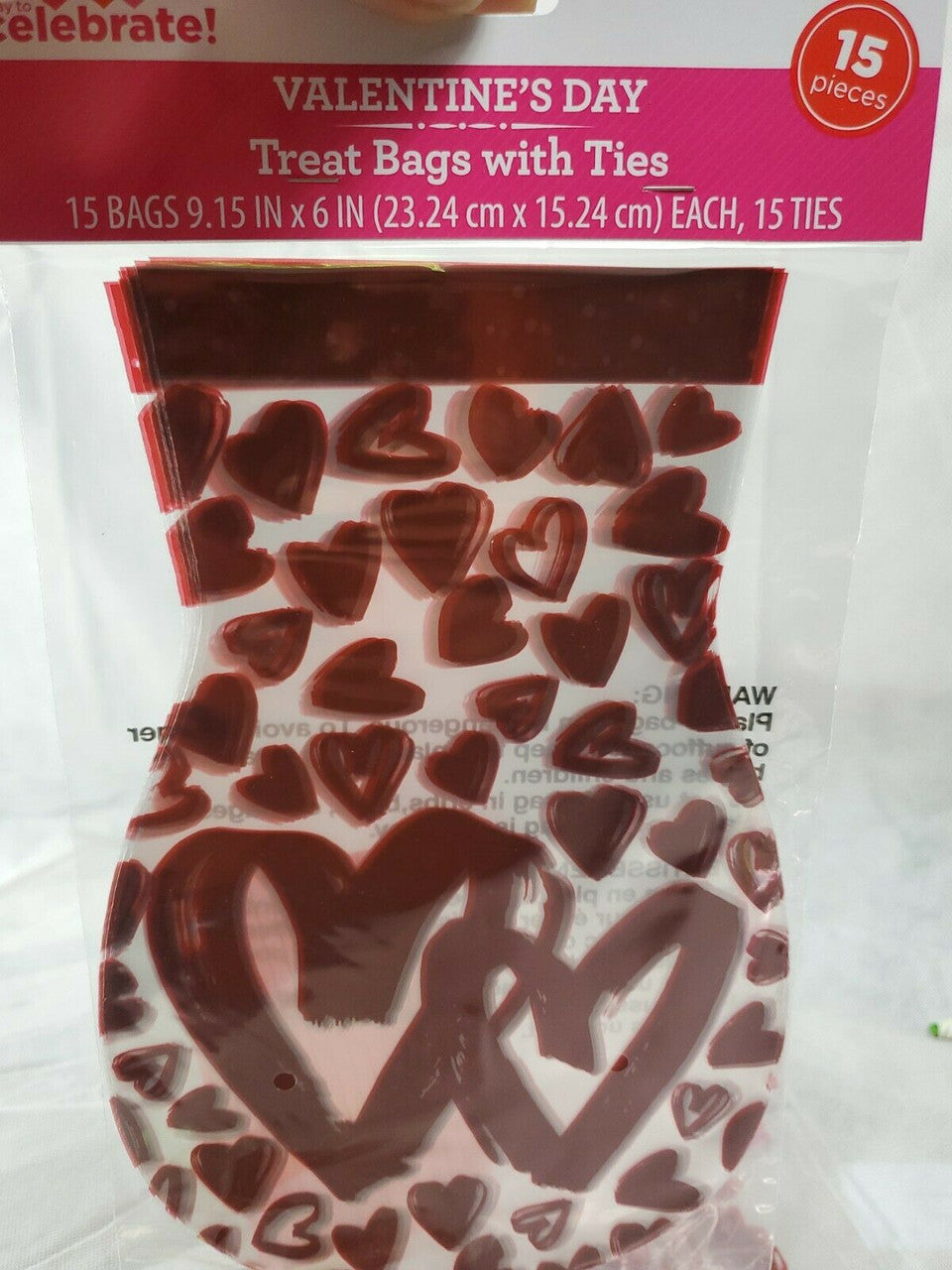 Valentine's Day treat bags with red hearts and ties on a white background.