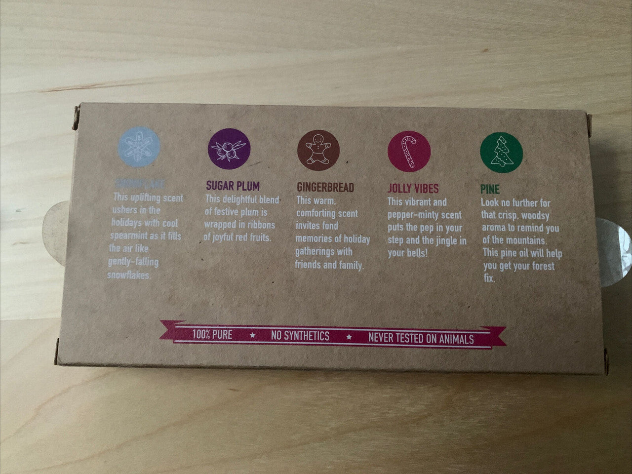 Scentsy candle box with branding and ingredient labels on a wooden surface