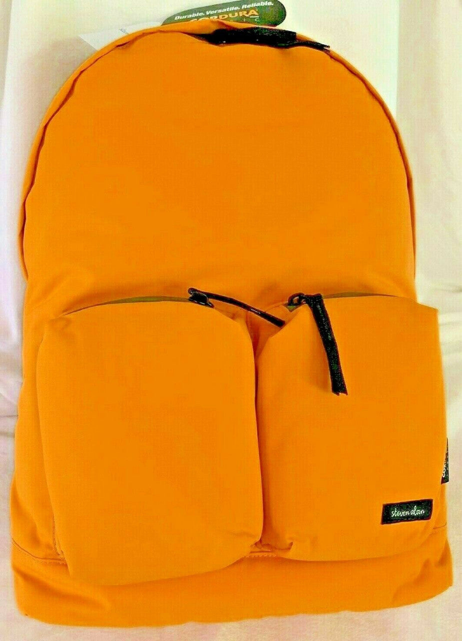 STEVEN ALAN Miles backpack in yellow with green zippers, navy straps, and a logo patch on the front. The backpack has two front zip pockets and appears to be made of non-leather fabric.