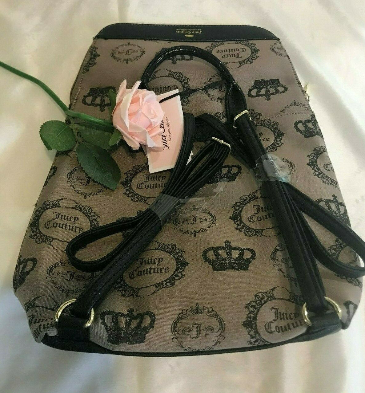 Beige and black canvas backpack with gold Juicy Couture logo and medallion design