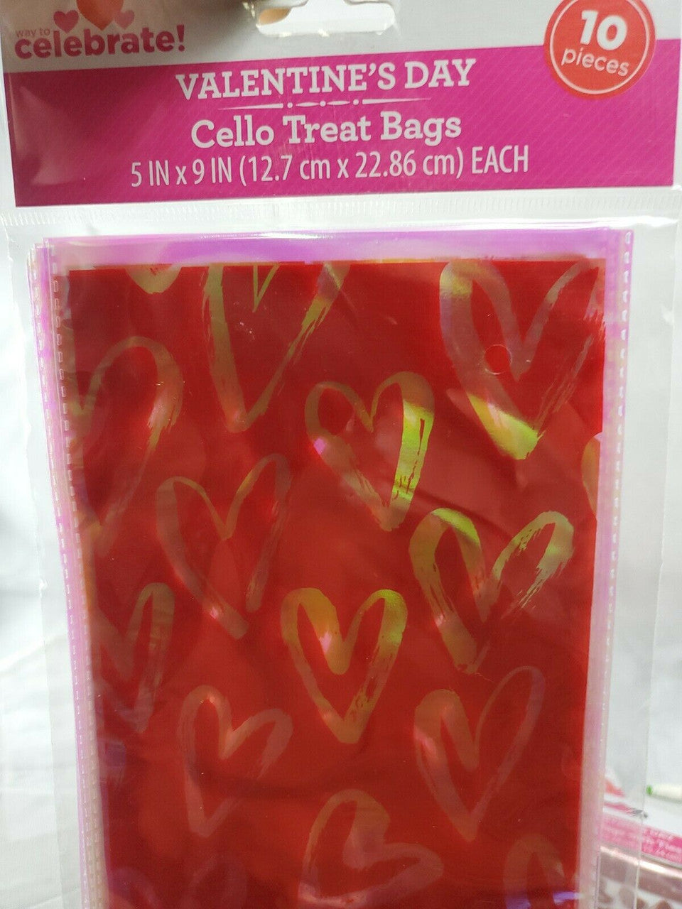 Six packs of Valentine’s Day treat bags in red with multi-colored hearts, mixed counts of ten and fifteen bags per pack.