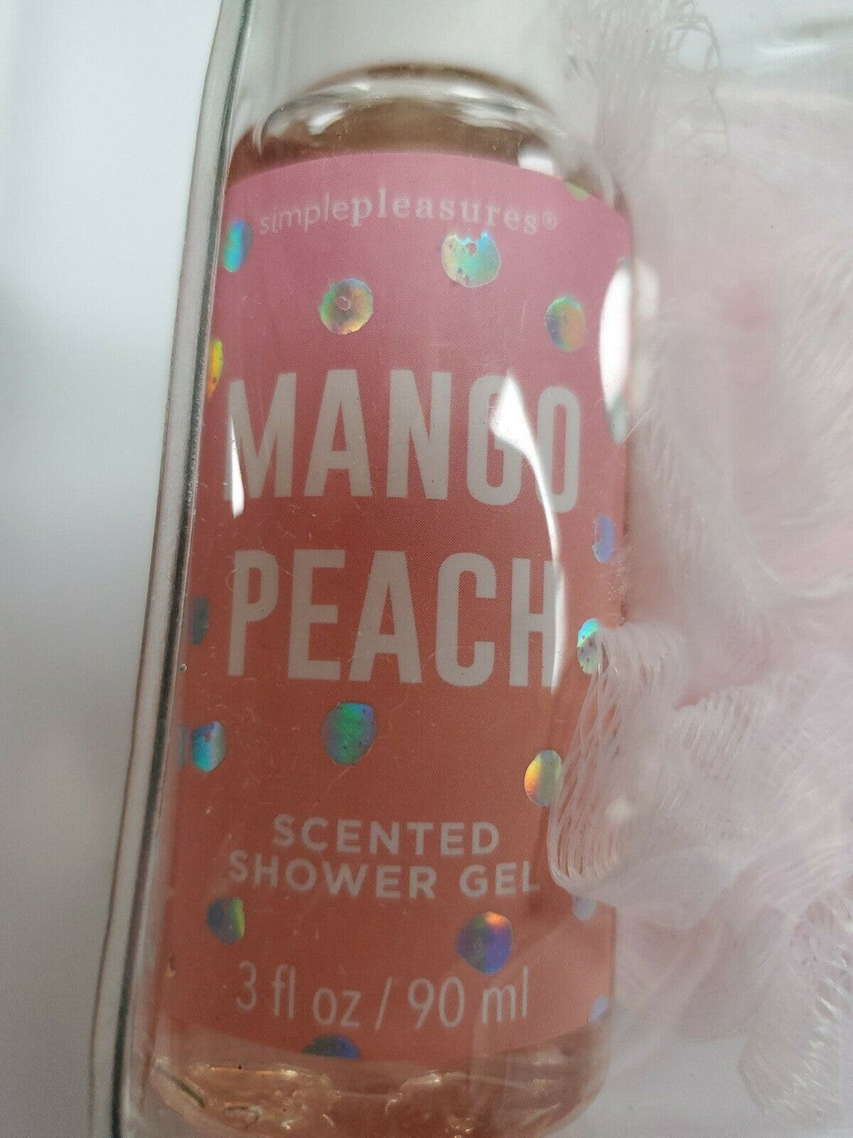 Bottle of mango peach scented shower gel with colorful labels.