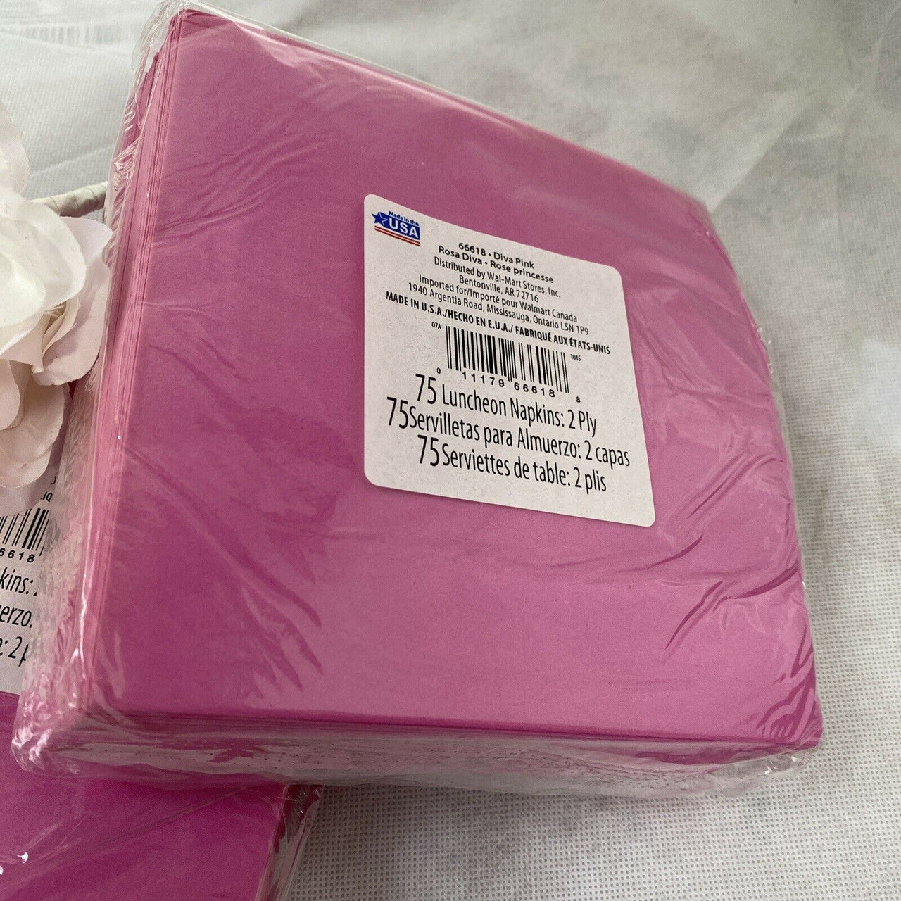 Two packs of pink paper luncheon napkins stacked in packaging, Diva Pink Princess 2-ply disposable napkins made in the USA