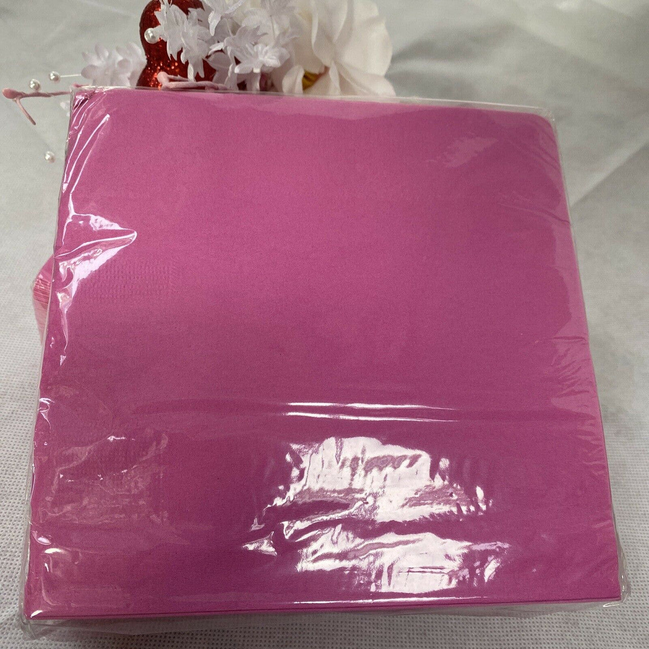 Two packs of pink paper luncheon napkins stacked in packaging, Diva Pink Princess 2-ply disposable napkins made in the USA