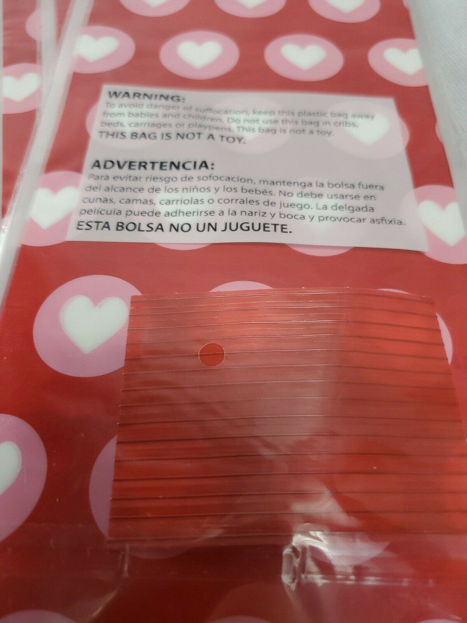 Red Valentine’s Day treat bags with white hearts, twelve retail packs with fifteen bags each and matching twist ties.