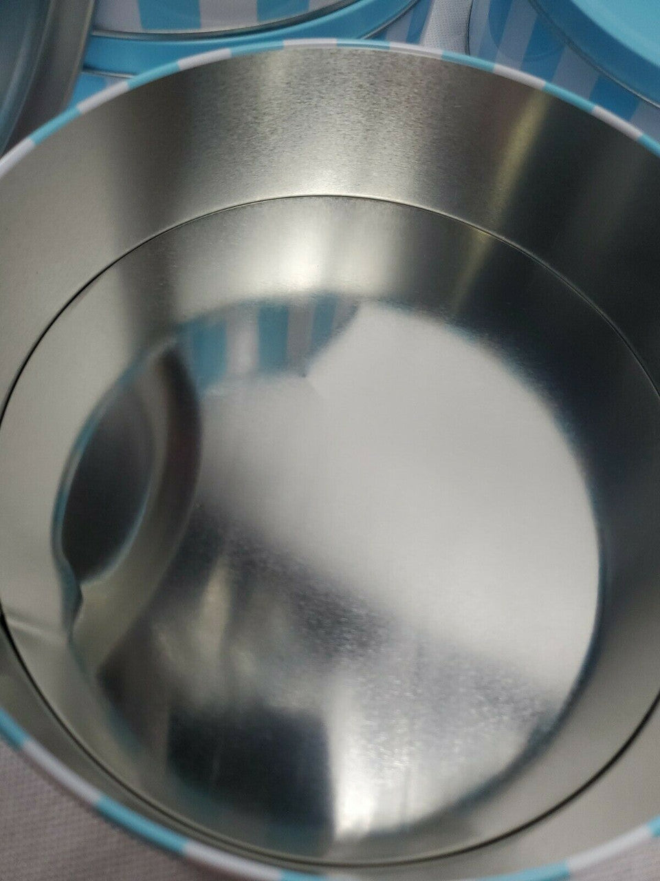 tin with reflective surface
