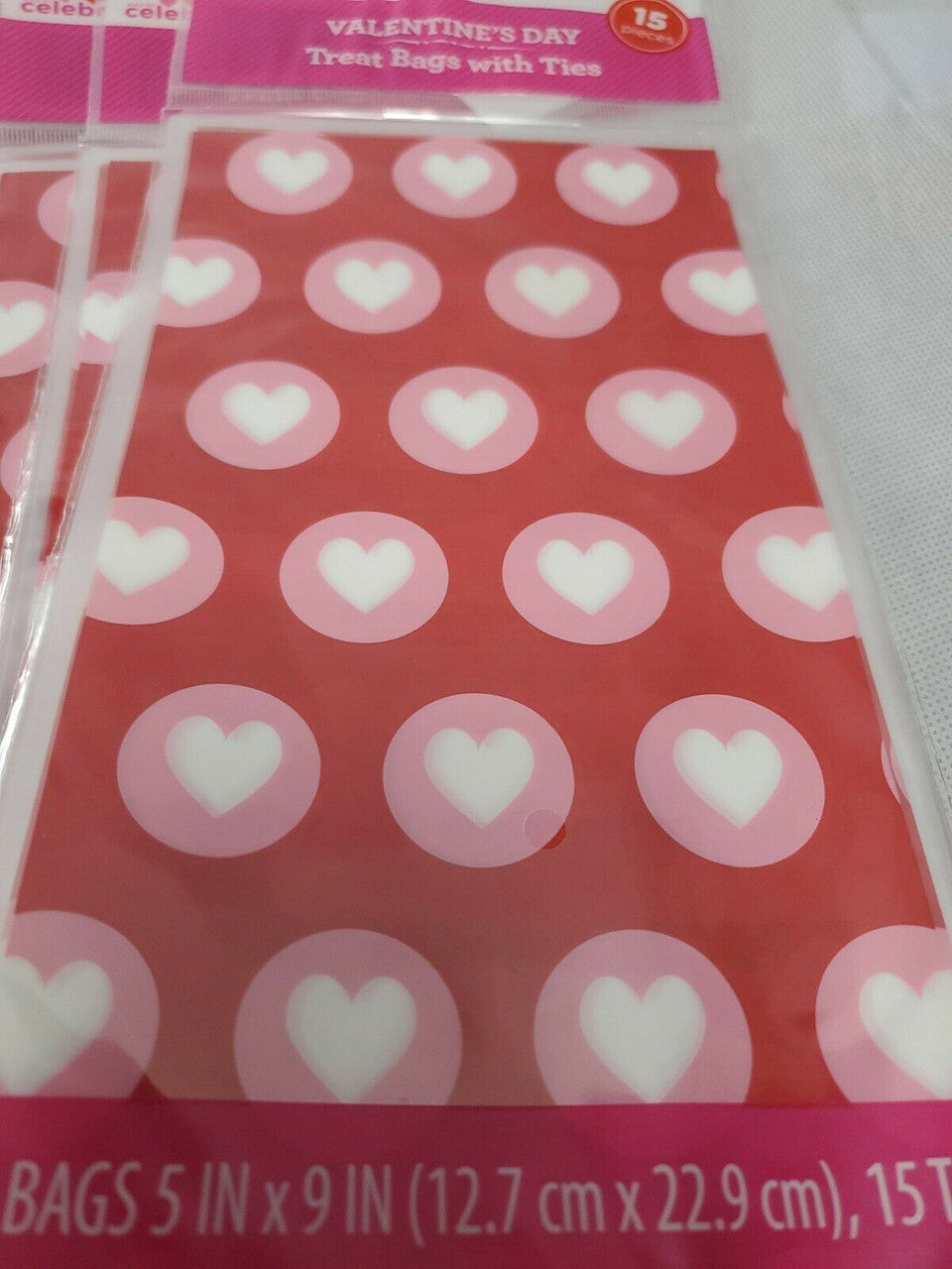 Red Valentine’s Day treat bags with white hearts, twelve retail packs with fifteen bags each and matching twist ties.