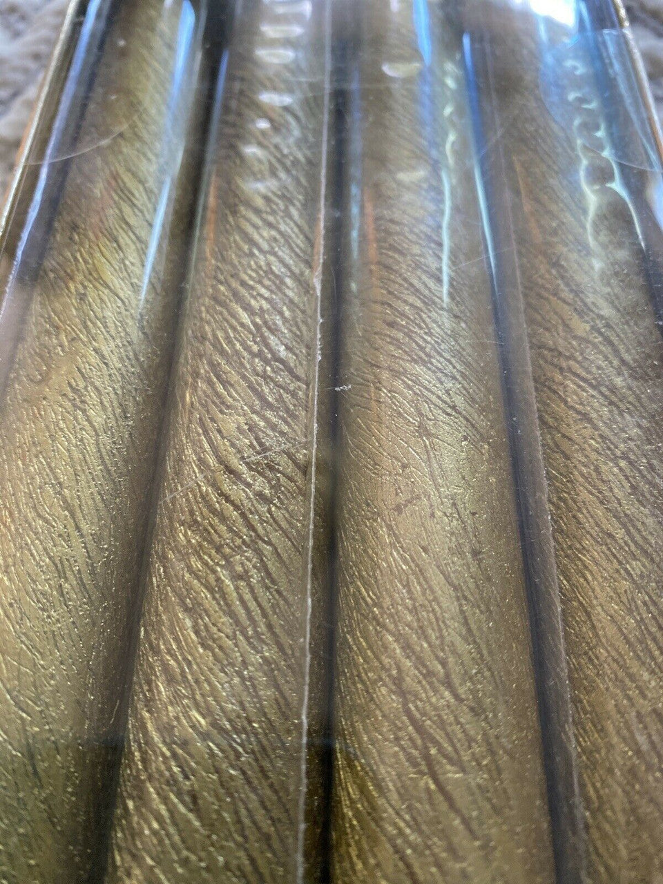 Set of 8 textured gold taper candles in original packaging, ideal for elegant dinner settings, events, or holiday decor.