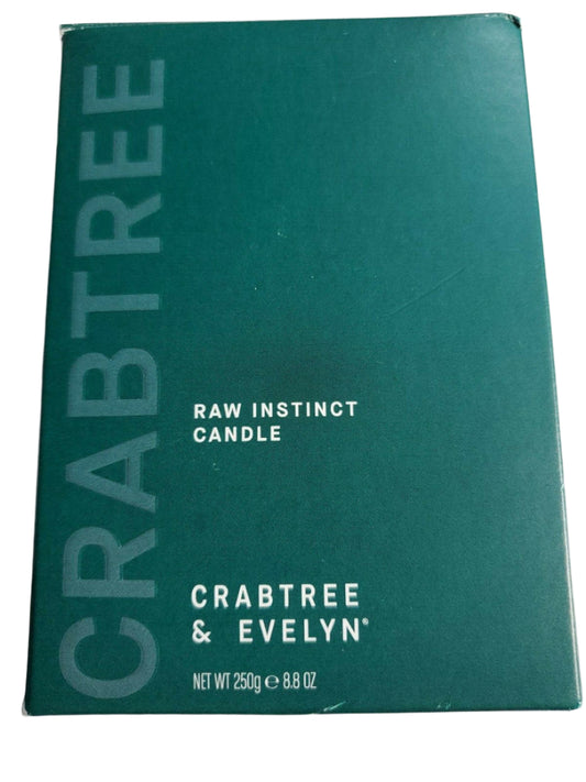 Crabtree & Evelyn Raw Instinct scented candle in green glass jar with copper lid, 8.8 oz premium soy wax blend.