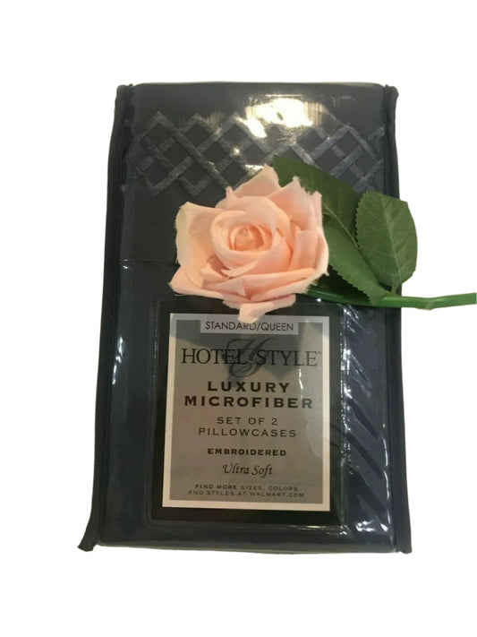 Set of 2 Hotel Style embroidered queen pillowcases in original packaging with flower accent