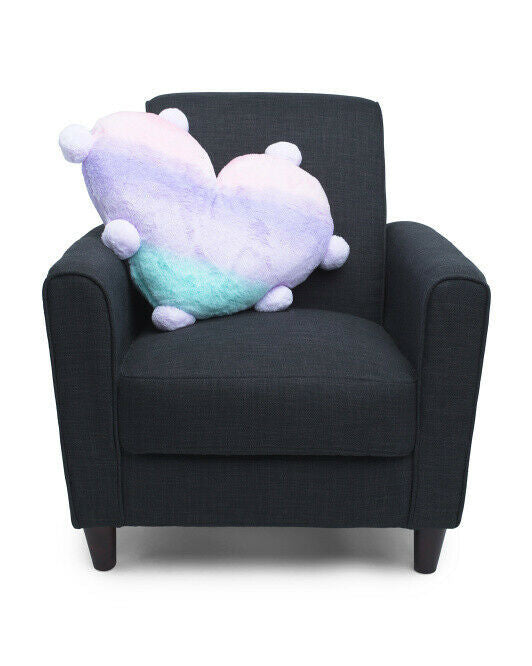 A heart-shaped, multicolored faux fur pillow on a black armchair.