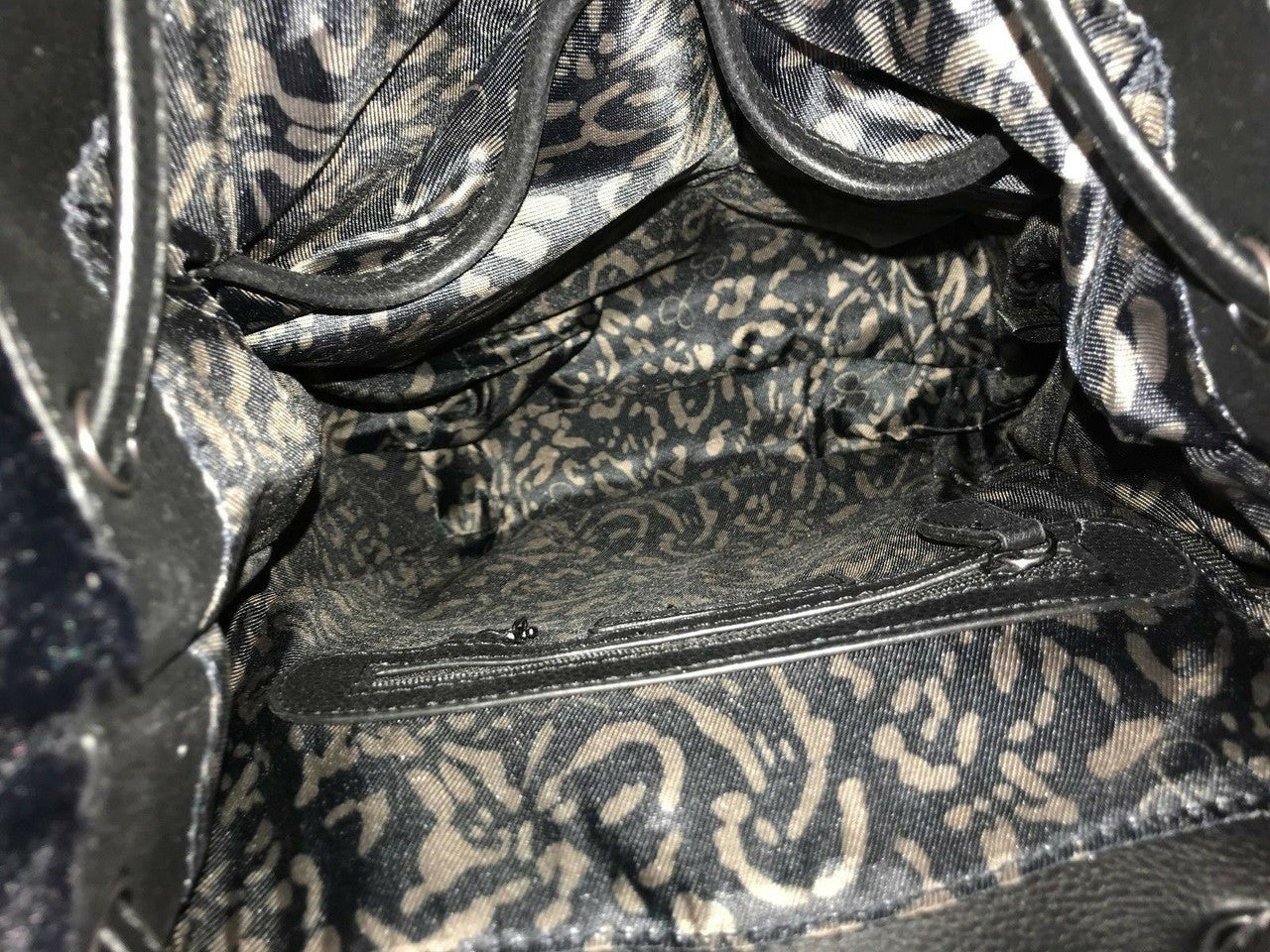 Jessica Simpson Kaelo black drawstring backpack with faux fur body and braided faux leather flap