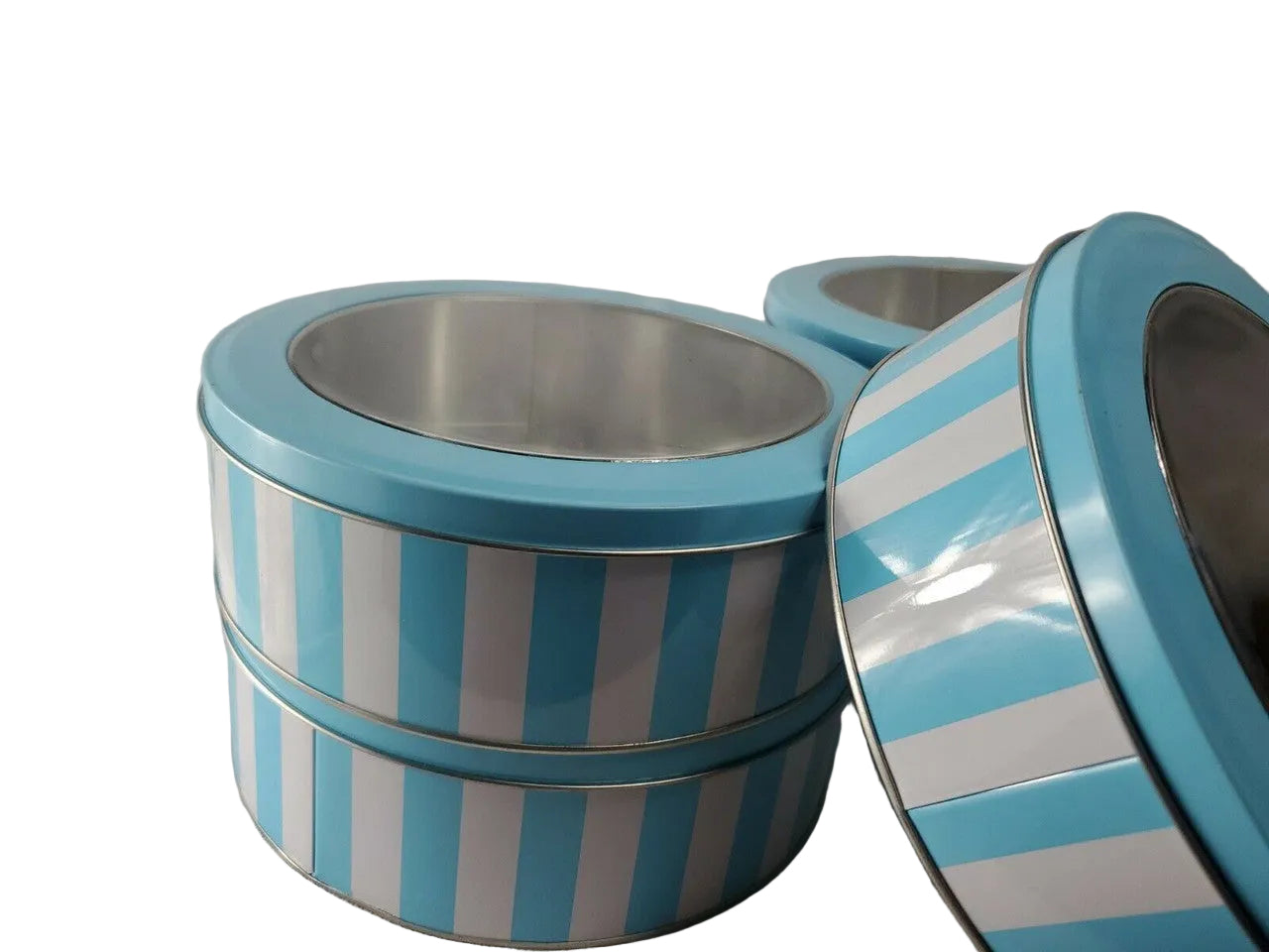 Stack of blue and white striped tin containers on a plain background