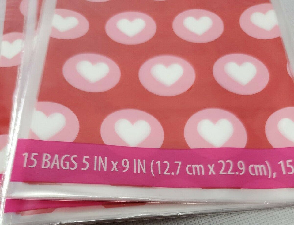 Red Valentine’s Day treat bags with white hearts, twelve retail packs with fifteen bags each and matching twist ties.