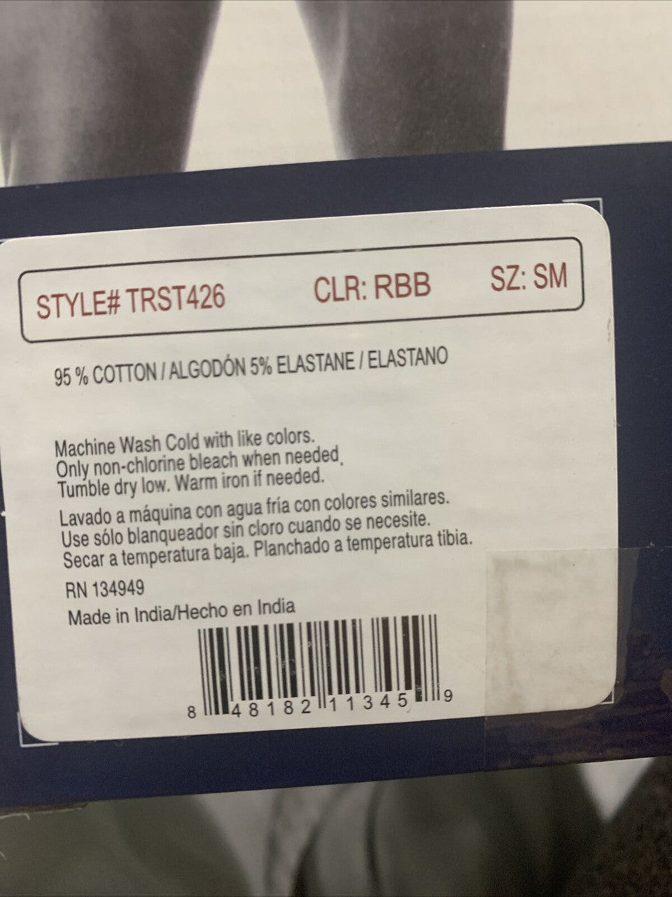 Fabric label with washing instructions and product details.