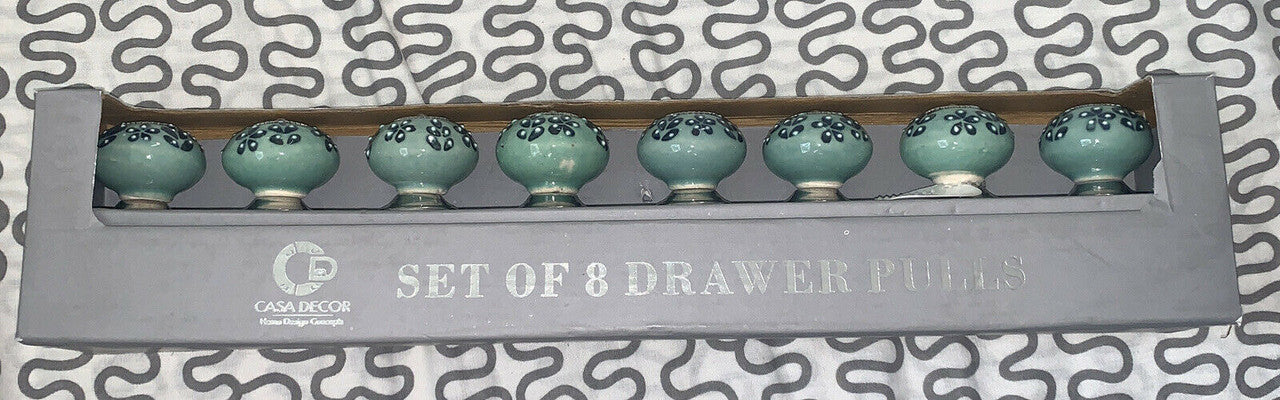 A set of 8 ceramic drawer pulls with a green and blue floral pattern, packaged in a gray box with the Casa Decor logo.