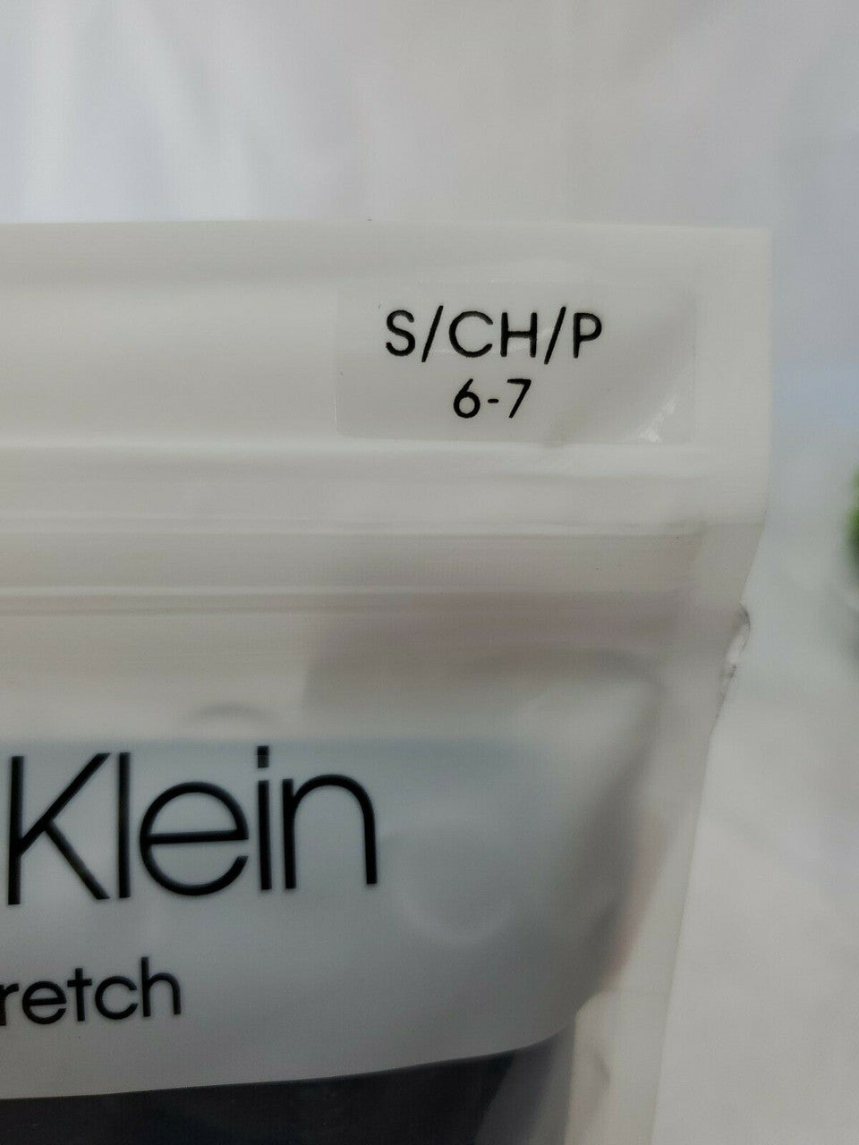 Calvin Klein boy’s boxer briefs, 2-pack cotton stretch underwear in size S (6-7), black/navy and stripe, shown in original packaging.