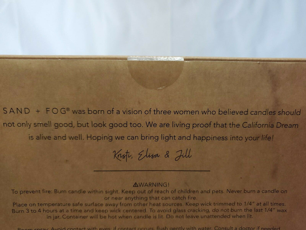 Gift set with Sand + Fog 8 oz teakwood candle and 100 ml room spray in amber containers, boxed for gifting.