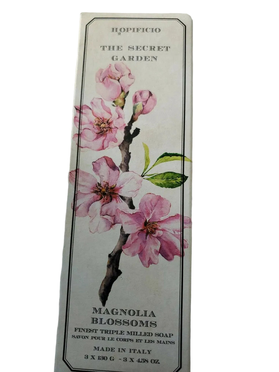Soap packaging with magnolia blossoms design on a white fabric background