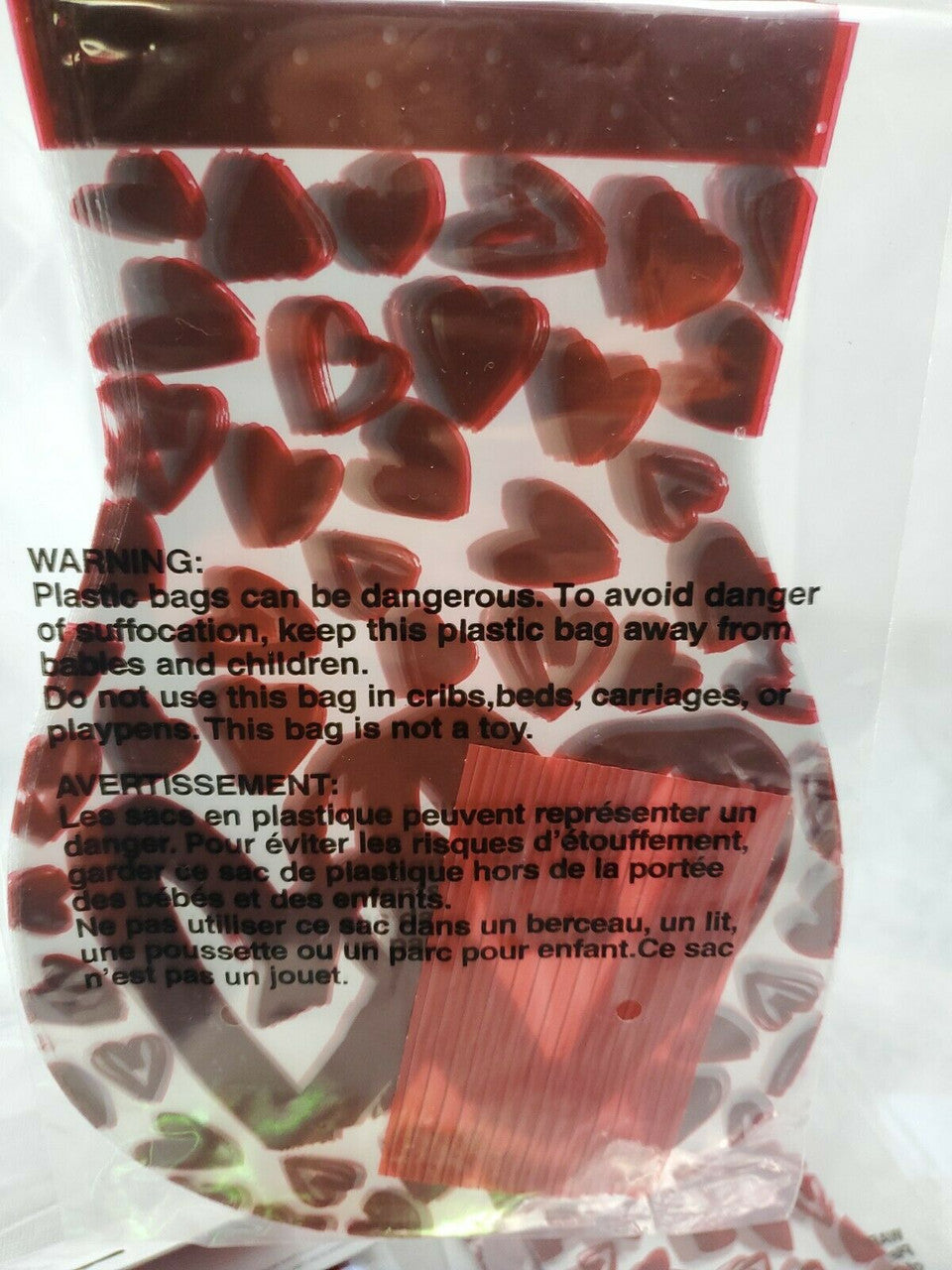 Six packs of Valentine’s Day treat bags in red with multi-colored hearts, mixed counts of ten and fifteen bags per pack.