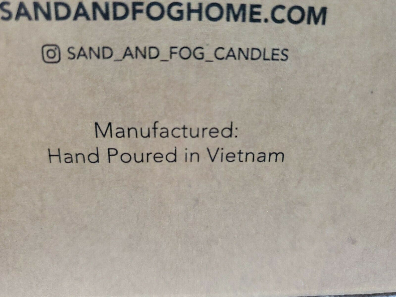 Gift set with Sand + Fog 8 oz teakwood candle and 100 ml room spray in amber containers, boxed for gifting.