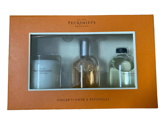 Pecksniff’s England Ginger Flower & Patchouli gift set including a reed diffuser and scented candle, packaged in an orange box.