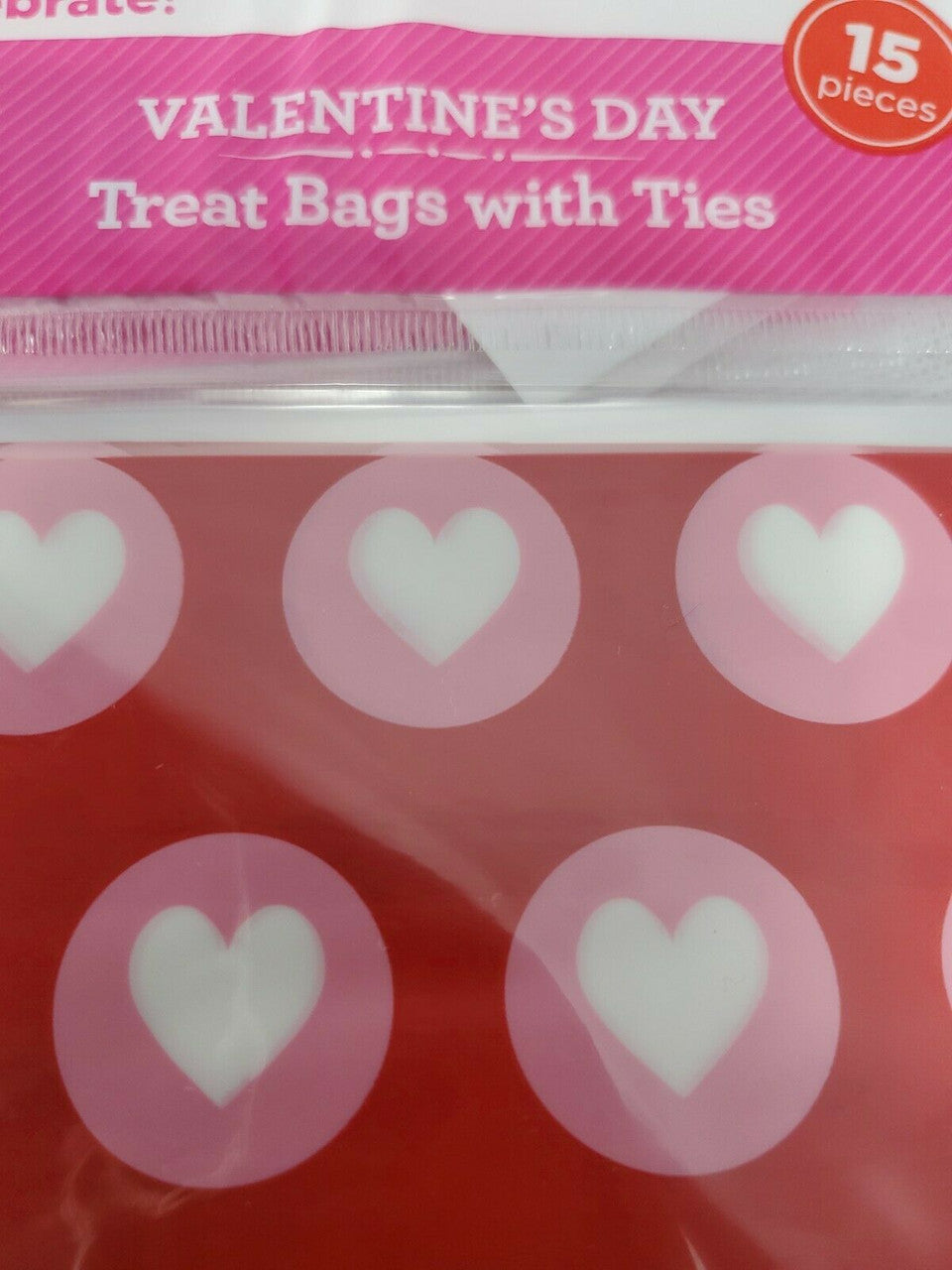 Valentine's Day treat bags with pink background and heart designs.