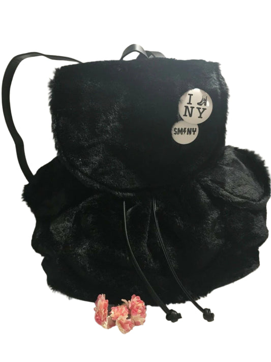 Steve Madden medium black faux fur backpack with decorative pin, side pockets, and drawstring flap