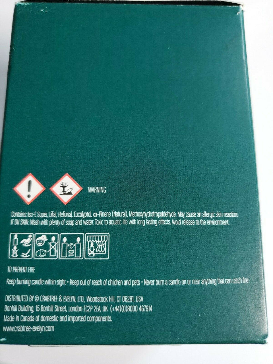 Crabtree & Evelyn Raw Instinct scented candle in green glass jar with copper lid, 8.8 oz premium soy wax blend.