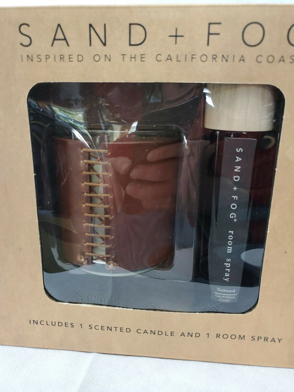 Gift set with Sand + Fog 8 oz teakwood candle and 100 ml room spray in amber containers, boxed for gifting.