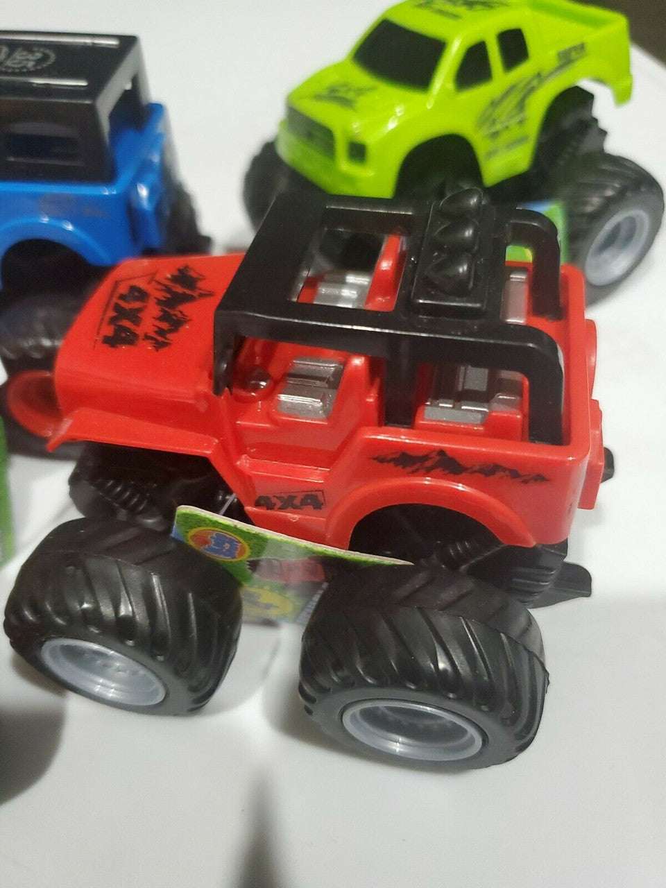 Friction powered 4WD jeep and monster truck toy set in packaging