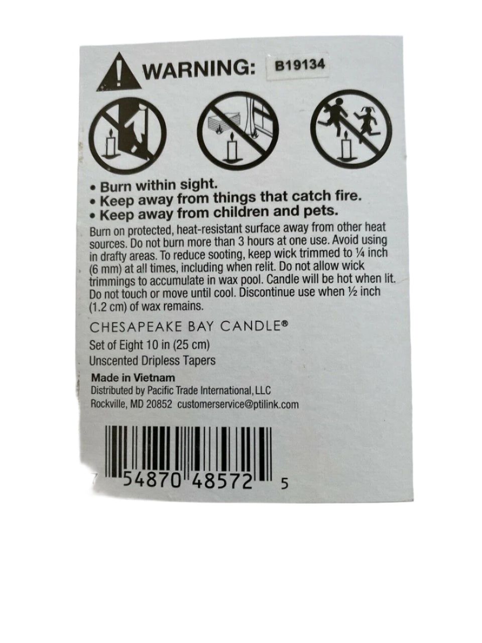 Set of 8 dripless unscented white taper candles in original packaging, ideal for elegant home decor or events