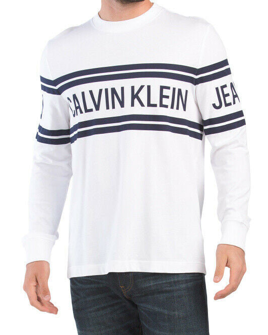 Calvin Klein Jeans white varsity logo long sleeve crew neck tee with ribbed collar and cuffs, featuring bold navy logo across chest and sleeves