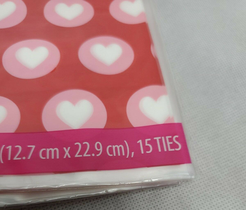 Red Valentine’s Day treat bags with white hearts, twelve retail packs with fifteen bags each and matching twist ties.