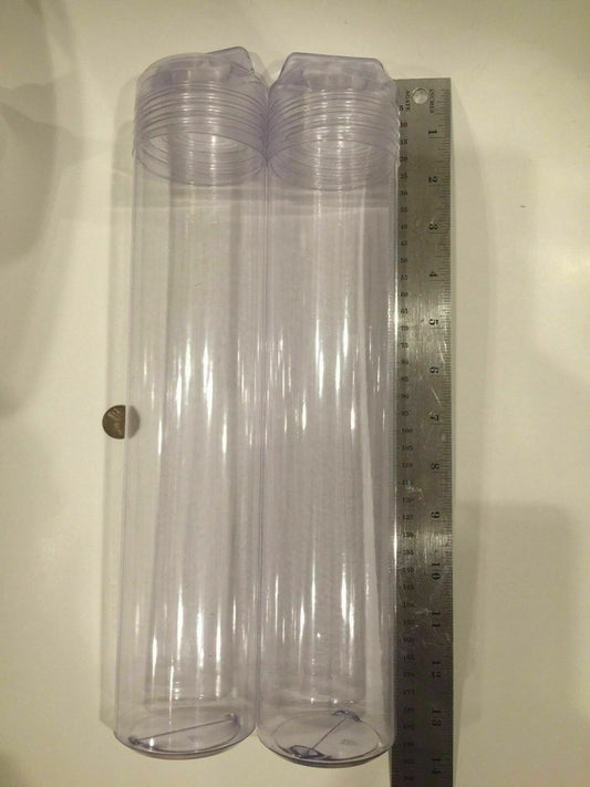 Three clear plastic tubes with hang caps placed next to a ruler for scale.
